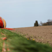 Roll of cable sitting in a field