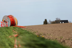 Roll of cable sitting in a field